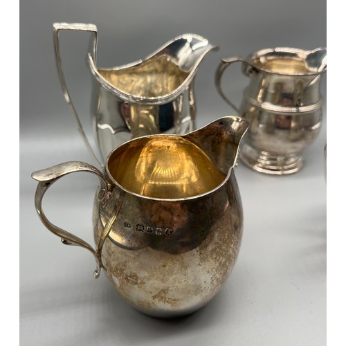 47 - Four Silver cream jugs. Small Georgian London jug with fancy trim. Jubilee marked London silver jug,... 