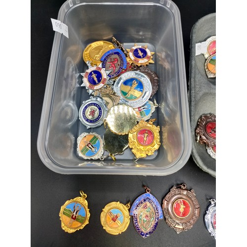 56 - Two trays of collectable Scottish dance badges and medals.