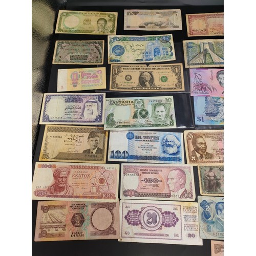 61 - A large selection of world bank notes from America, Denmark, Bahrain, Saudi Arabia, Iran, France and... 