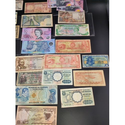 61 - A large selection of world bank notes from America, Denmark, Bahrain, Saudi Arabia, Iran, France and... 