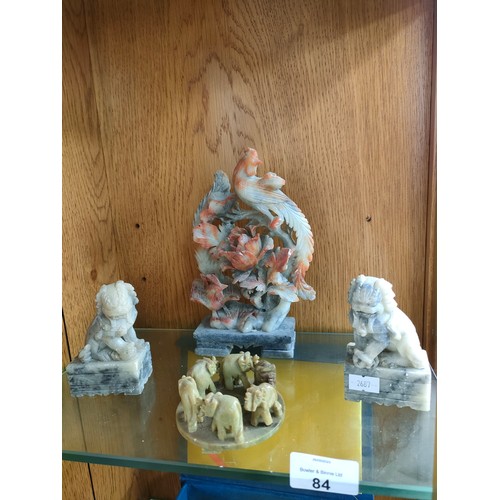 84 - A Shelf of oriental soapstone figures including foo dogs, elephants and birds