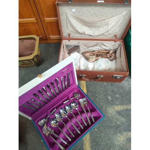 132 - Vintage suitcase containing canteen of cutlery and vintage babies shoes and waistcoats along with si... 