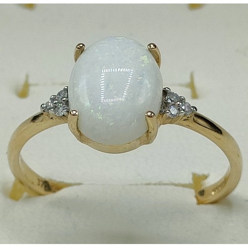 40 - 9ct yellow gold ring set with a large opal stone off set by diamond shoulders. [Ring size S] [2.12Gr... 