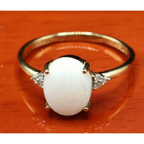 40 - 9ct yellow gold ring set with a large opal stone off set by diamond shoulders. [Ring size S] [2.12Gr... 