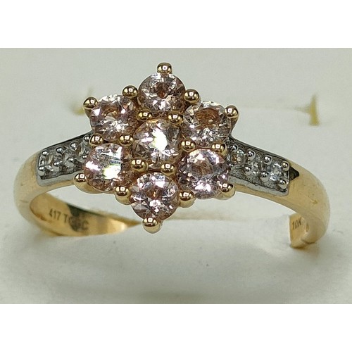 43 - 10ct yellow gold ladies ring set with seven pale pink gem stones off set by white spinel stones. [Ri... 