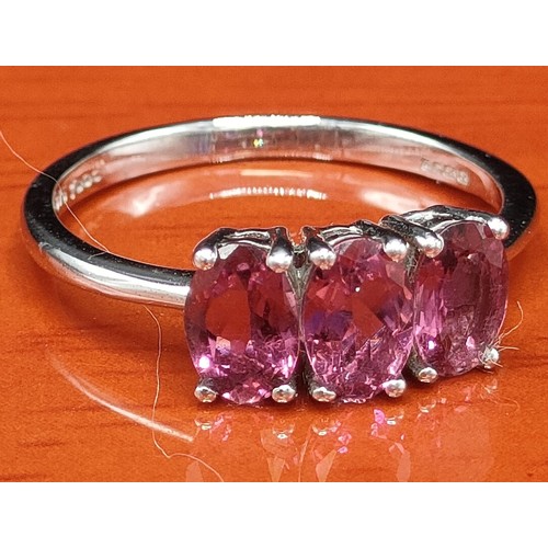 48 - 10ct white gold ring set with three purple gem stones. [Ring size M 1/2] [1.92Grams]