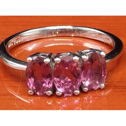 48 - 10ct white gold ring set with three purple gem stones. [Ring size M 1/2] [1.92Grams]