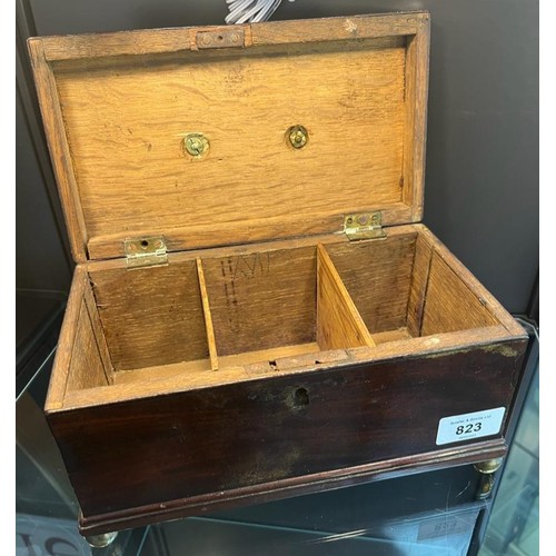 823 - 19th century mahogany lidded storage box, brass swing handle to lid and sat upon four brass bun feet... 