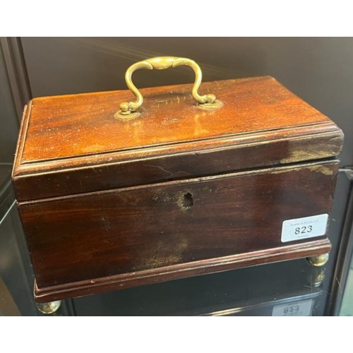 823 - 19th century mahogany lidded storage box, brass swing handle to lid and sat upon four brass bun feet... 