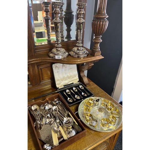 826 - A Selection of silver plated ware to include ornate candle sticks, serving tray, canteen of tea spoo... 