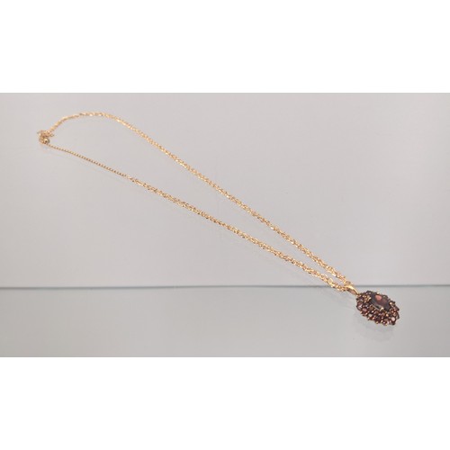 735 - A 9ct yellow gold ladies necklace with a 9ct yellow gold and Garnet cluster pendant. [4.66grams]