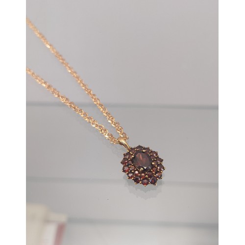 735 - A 9ct yellow gold ladies necklace with a 9ct yellow gold and Garnet cluster pendant. [4.66grams]