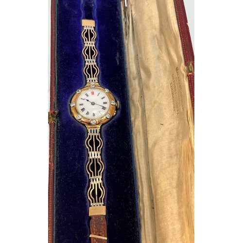 727 - A Ladies 15ct yellow gold, Platinum and diamond set bracelet watch. white enamel face with roman num... 