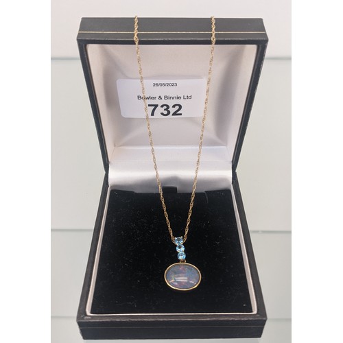 732 - 9ct yellow gold necklace with a 9ct gold, Large opal and three Aquamarine stone pendant. [3.33grams]