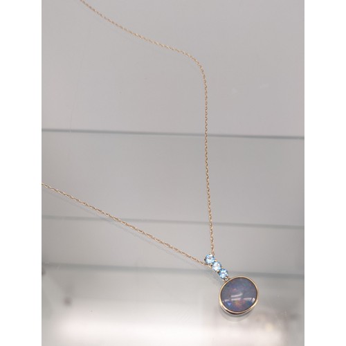 732 - 9ct yellow gold necklace with a 9ct gold, Large opal and three Aquamarine stone pendant. [3.33grams]