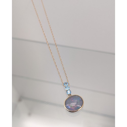 732 - 9ct yellow gold necklace with a 9ct gold, Large opal and three Aquamarine stone pendant. [3.33grams]