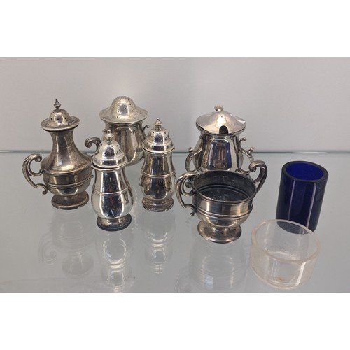 721 - A Collection of silver marked condiment pots, includes Glasgow silver art nouveau inspired pepper po... 