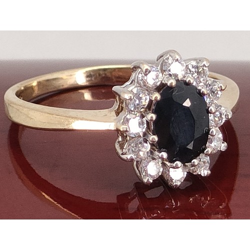 39A - 9ct yellow gold ladies ring set with a large Sapphire off set by white stones. [Ring size P] [2.65Gr... 