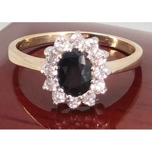 39A - 9ct yellow gold ladies ring set with a large Sapphire off set by white stones. [Ring size P] [2.65Gr... 