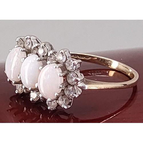 742 - 9ct yellow gold ladies ring set with three opal stones surrounded by white spinel stones. [Ring size... 