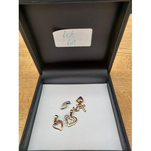 6A - A Selection of 9ct gold; two heart shaped 9ct yellow gold pendant, Trio of 9ct yellow gold charm pen... 