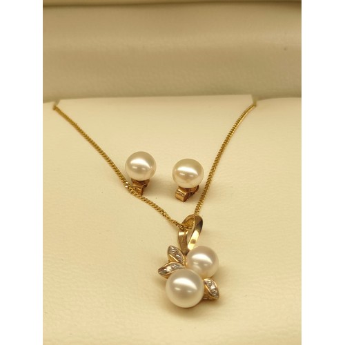 20A - 9ct yellow gold ladies necklace with 9ct gold diamond and pearl pendant with matching earrings.