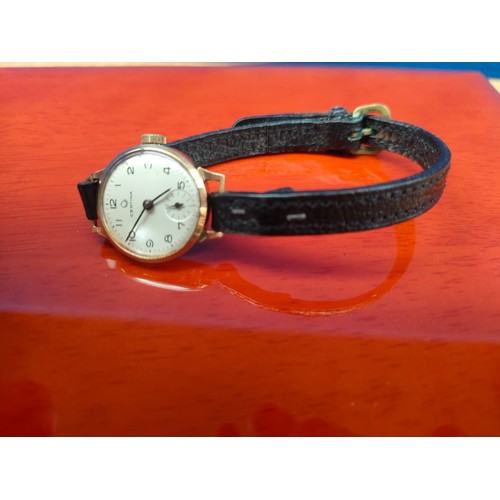 55A - 9ct yellow gold cased ladies Certina watch in a working condition. Fitted with a leather strap.