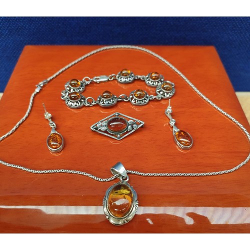 42A - Silver and amber matching jewel set. Pendant, brooch, earrings and bracelet.