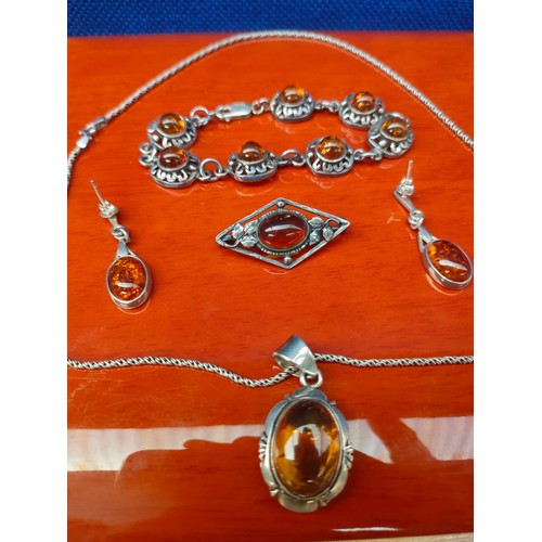 42A - Silver and amber matching jewel set. Pendant, brooch, earrings and bracelet.