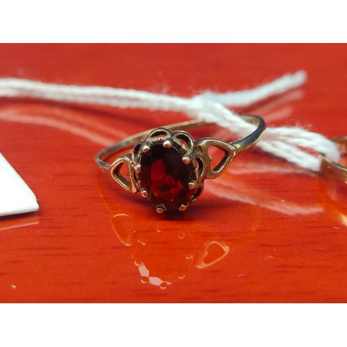 40A - Two 9ct yellow gold rings. One set with a single CZ Stone and the other with a single Garnet stone. ... 