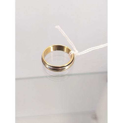 706 - 18ct yellow and white gold wedding band. [7.66grams] [Ring size V] [White gold band movable]