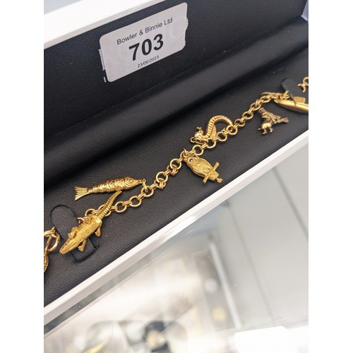 703 - 18ct yellow gold [750] charm bracelet with four 18ct yellow gold charms and three 9ct yellow gold ch... 