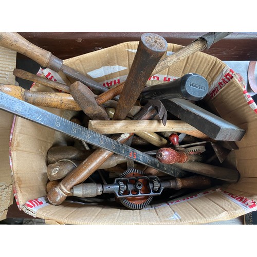 69 - A box of antique tools to include J.A. Chapman hand turning drill, hammers and chisels