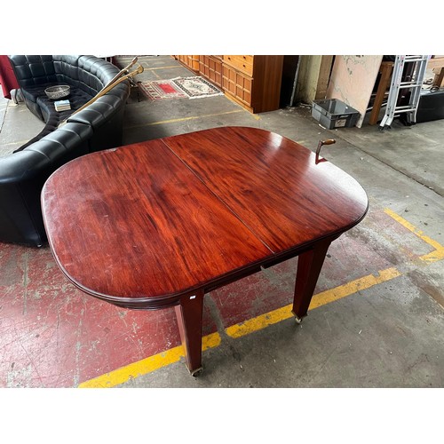 101 - A Large 19th century wind out mahogany dining table, 4 leaves. 11 foot by 4 foot. Has Square tapered... 