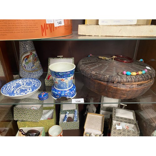 150 - Two shelves of Chinese related items; Antique Chinese Sewing Basket, various boxed small vases and s... 