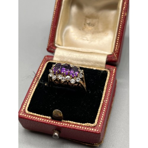 725 - Ladies 9ct yellow gold ring; set with three oval cut amethysts surrounded by white gem stone cluster... 