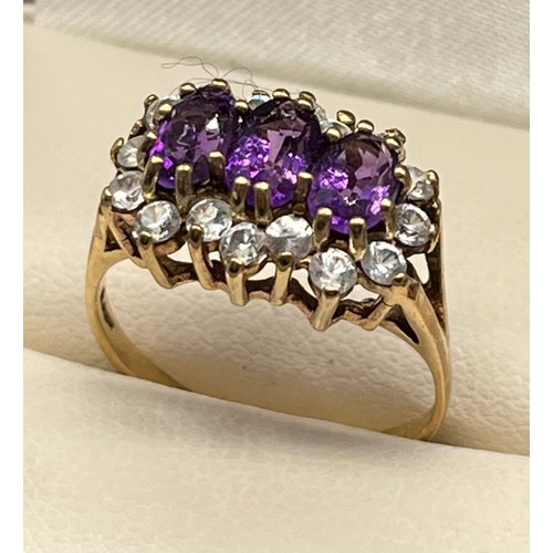 725 - Ladies 9ct yellow gold ring; set with three oval cut amethysts surrounded by white gem stone cluster... 