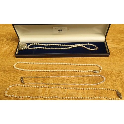 45 - Four various pearl and silver clasp necklaces.