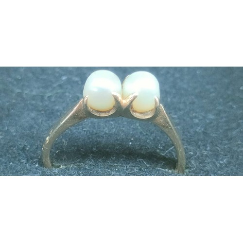 39 - Two 9ct yellow gold rings fitted with pearls; One ring fitted with a single pearl and off set by sin... 