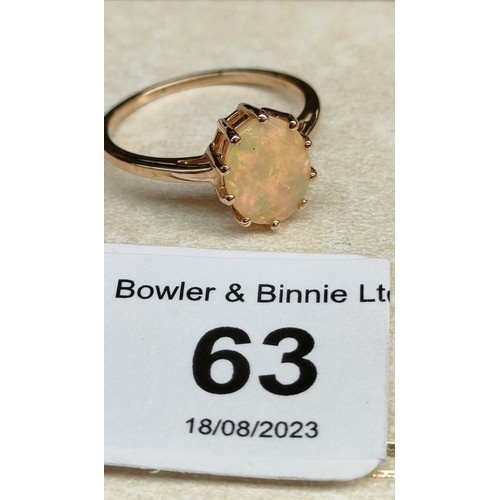 63 - 10ct yellow gold ladies ring set with a single Ethiopian opal stone. [Ring size R] [2.46Grams]