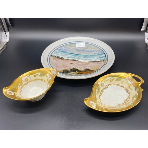 1005 - A Scottish Highland pottery plate along with a pair of Limoges dishes