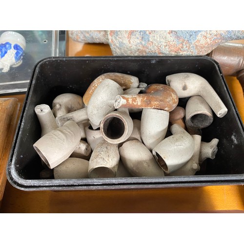 24 - A collection of Framed clay pipes together with a terracotta two handled urn