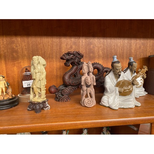 26 - A shelf of oriental collectable figures