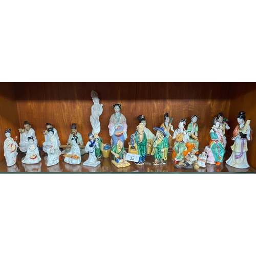 28 - Two shelves of oriental porcelain and wooden carved figures to include terracotta style figures and ... 