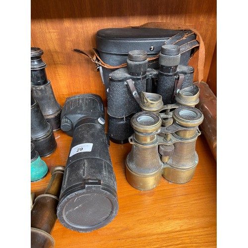 29 - A large collection of binoculars to include Strand London and brass telescopes