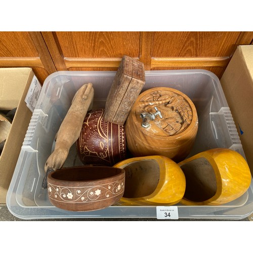 34 - Box of wooden items; Carved barrel with metal pourer, Pair of painted wooden clogs and African pot.