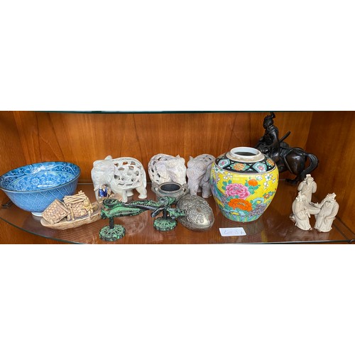 37 - Two shelves of oriental collectables; Mud men figures, Junk boat models, Bronze figure on horse as f... 