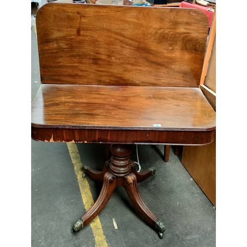 263 - 19th century mahogany games table, the flop top above a baluster column raised on four scroll out sw... 