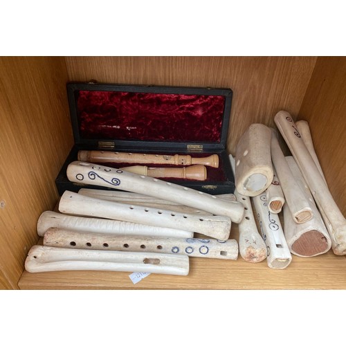 371 - Two boxes containing JAW Harps, Shelf of Bone worked flutes and wooden flutes