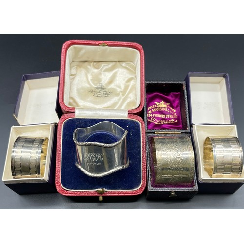 1176 - Four various boxed Silver napkin rings; Pair of silver machine worked napkin rings, Victorian Edinbu... 